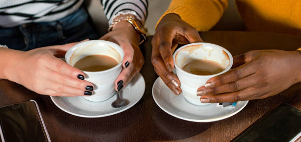 Two friends sharing coffee at a celebration