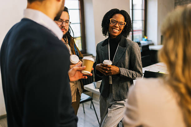 Team members chatting over coffee during a workplace event