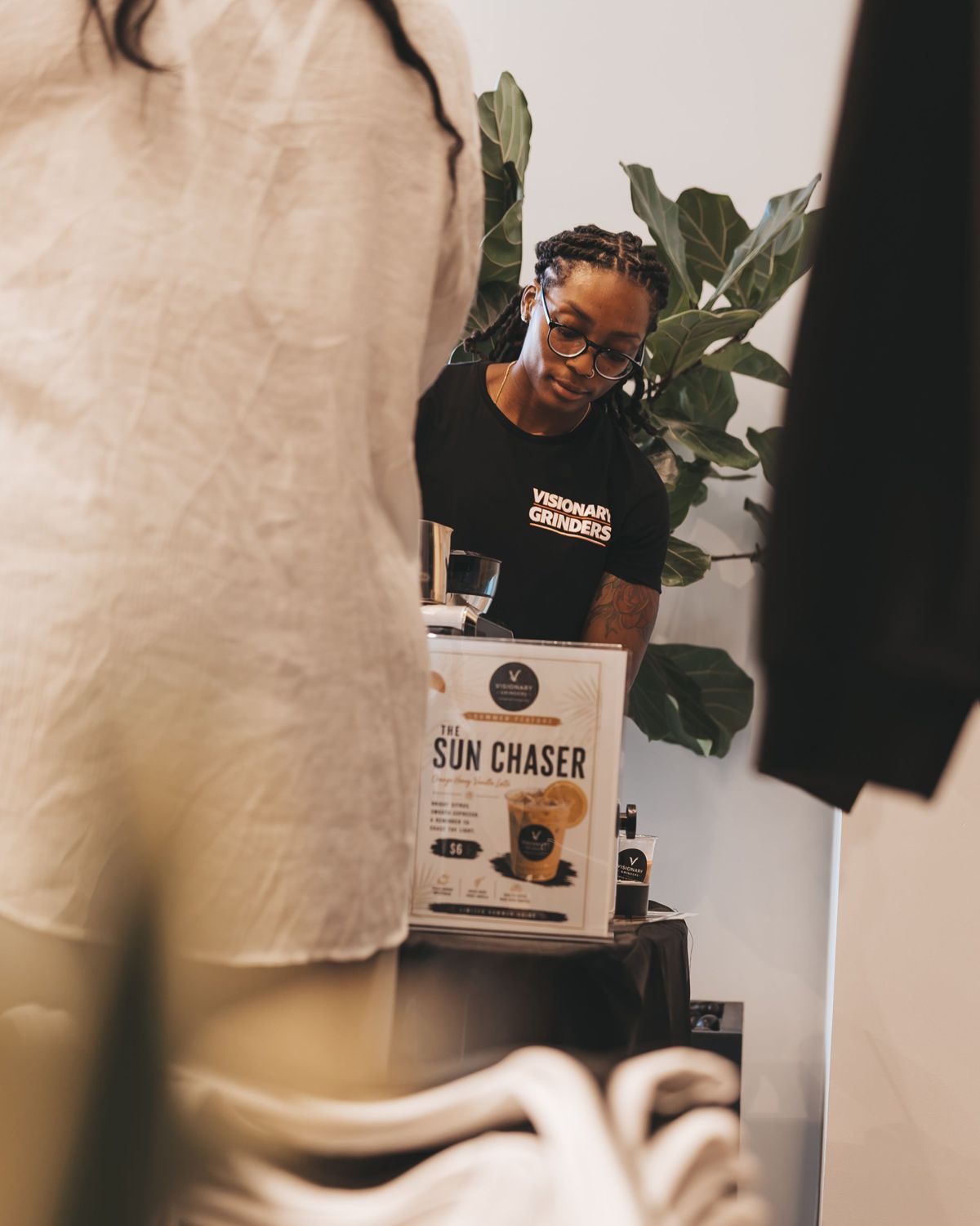 Visionary Grinders pop-up coffee bar with a menu sign and espresso setup at an event in Houston
